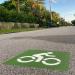 Bicyclist sign painted on road in white with great background.