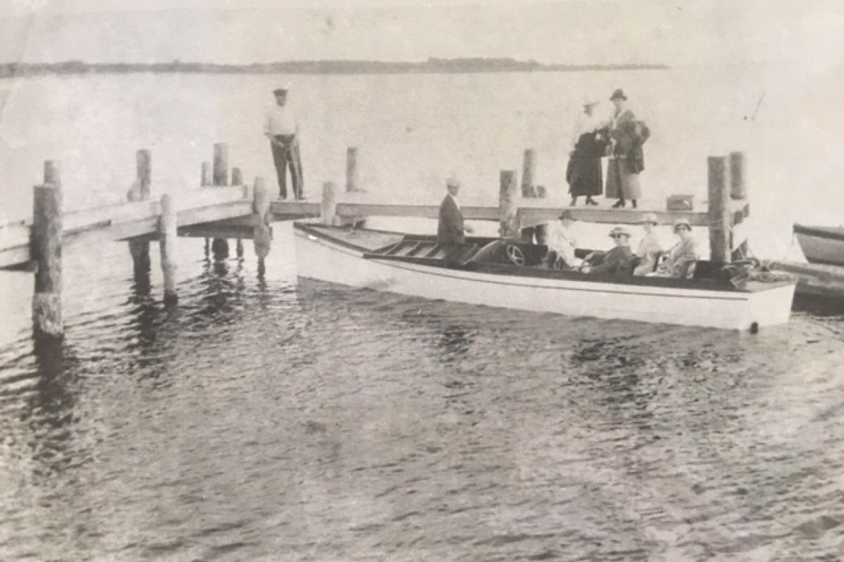 historical photo of men on a small boat