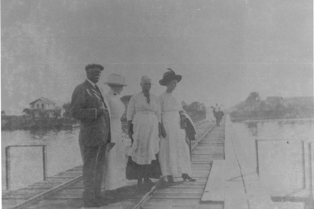 historical photo of men and women on the pier