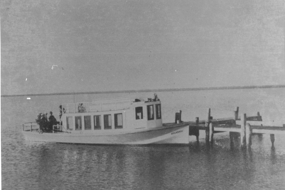 historical photo of ferry boat docked at pier